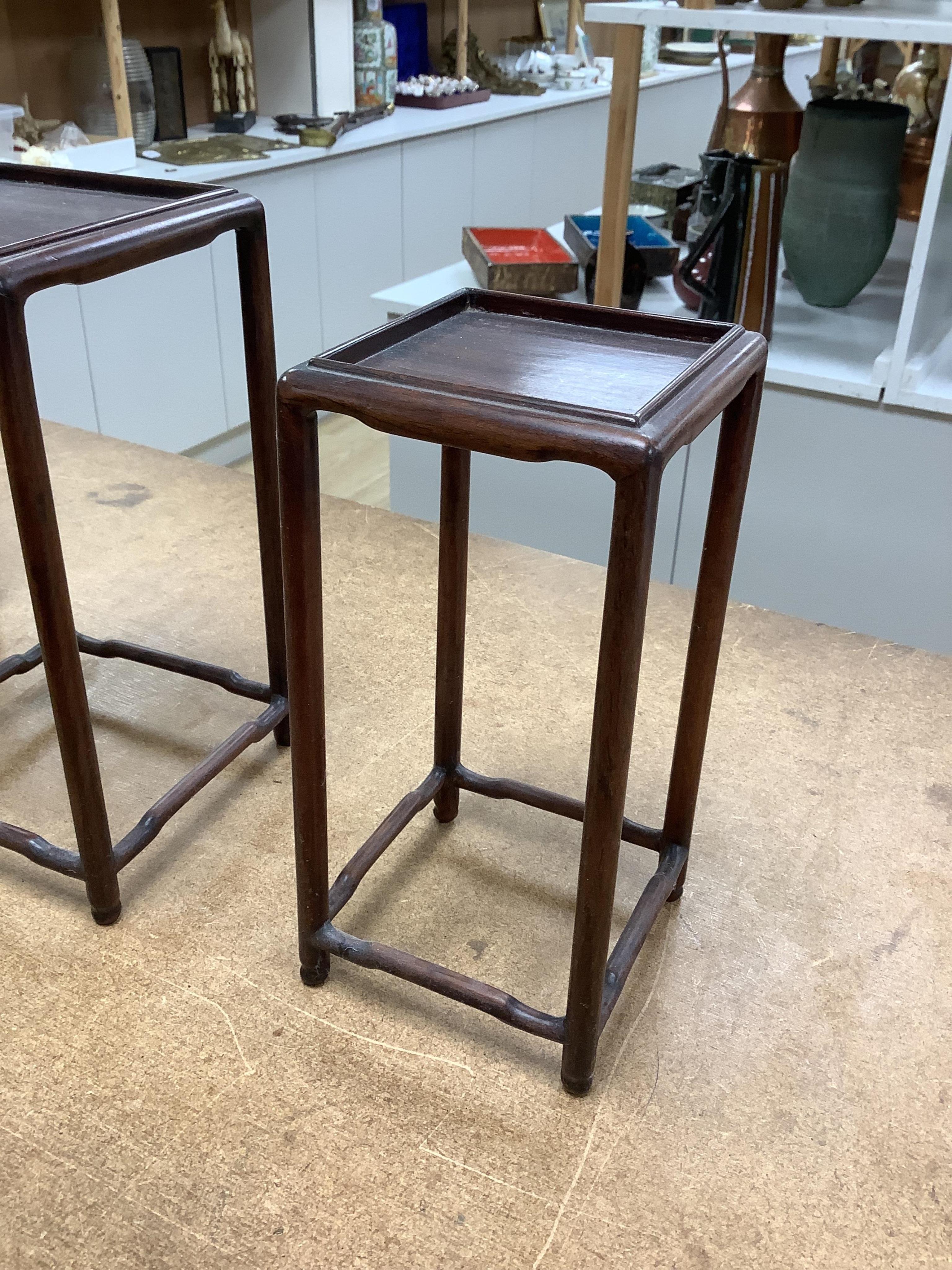 A nest of five Chinese hardwood stands, tallest (largest) 32cm high